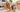 Golden retriever and tabby cat beside shed pet hair on a hardwood floor and living-room rug